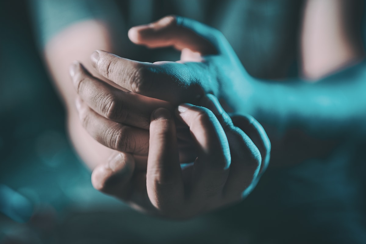 Person massaging a sore wrist, illustrating carpal tunnel syndrome