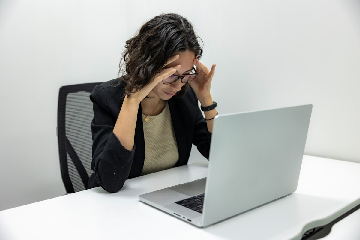 Person pressing hands against their forehead due to a tension headache