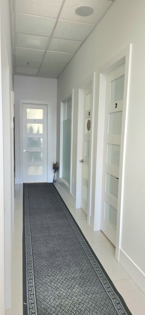 Clean hallway leading to the private treatment rooms